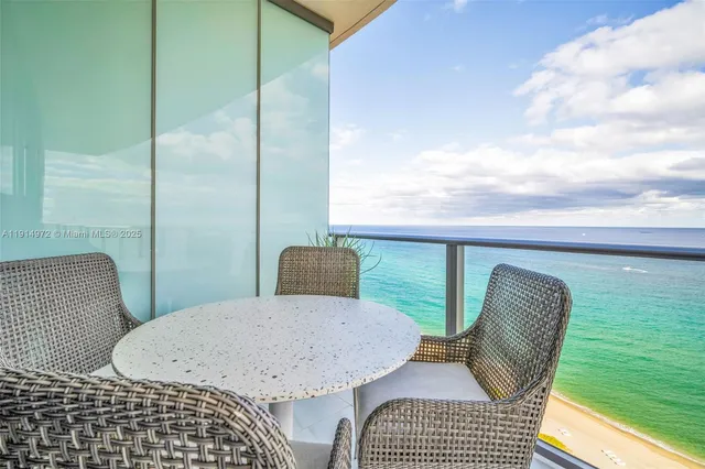 a spacious bedroom with a bed and glass windows