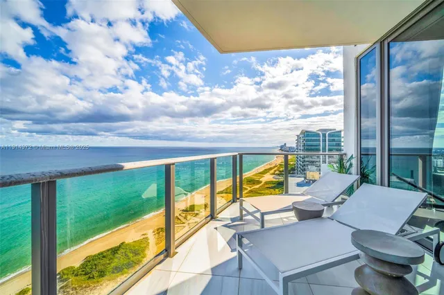a view of a patio with couches chairs and city view