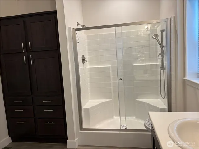 a bathroom with a shower and a tub