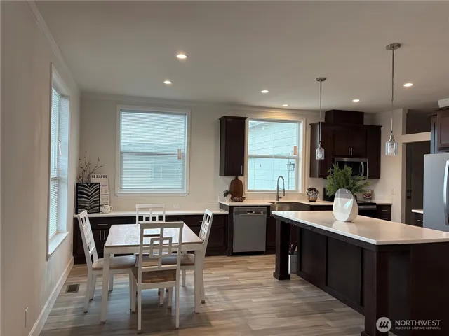 a large kitchen with lots of counter space dining table and chairs