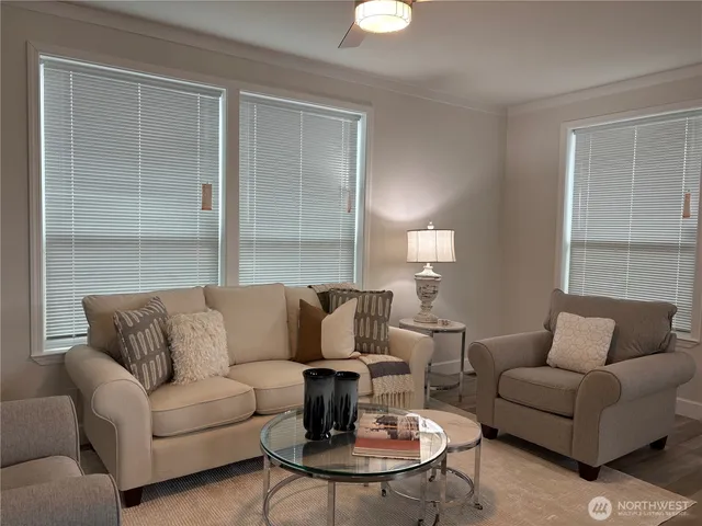 a living room with furniture and a potted plant