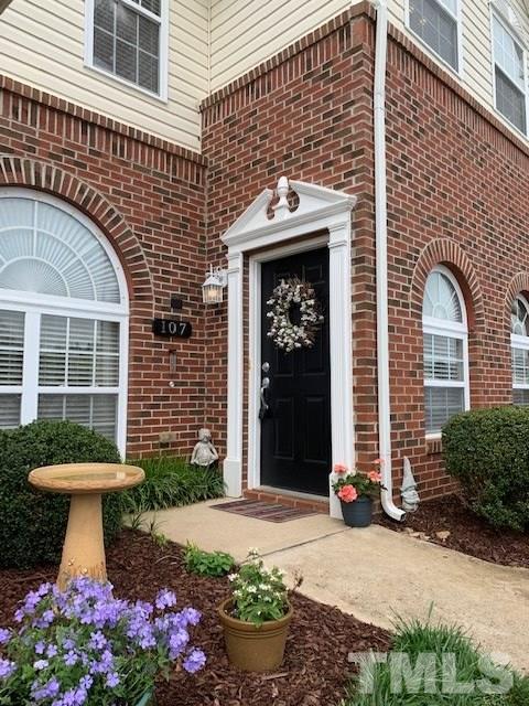 2111 Piney Brook Road, Unit 107 Raleigh, NC 27614 - Photo 3 of 23 a front view of a house with a garden