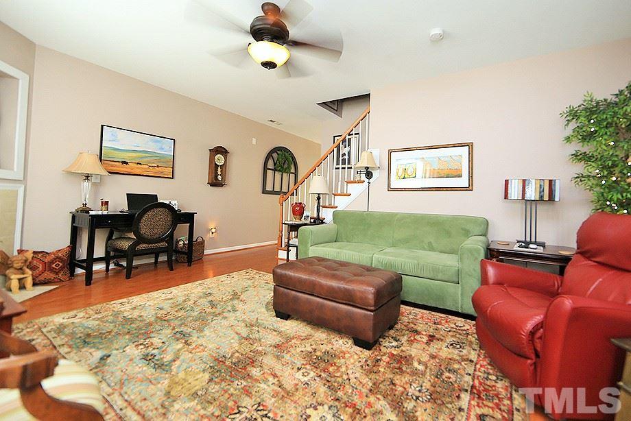 2111 Piney Brook Road, Unit 107 Raleigh, NC 27614 - Photo 4 of 23 a living room with furniture and wooden floor