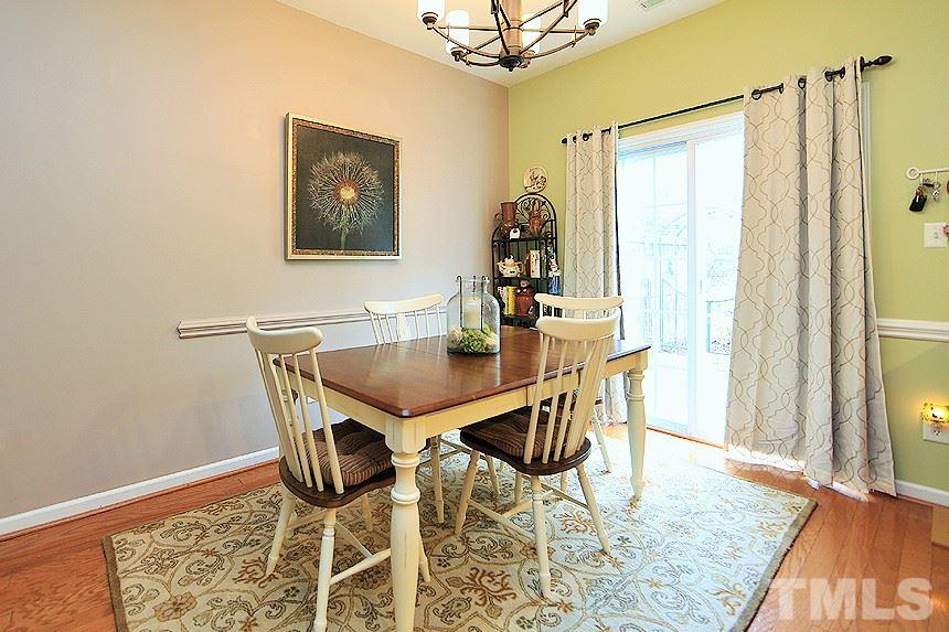 2111 Piney Brook Road, Unit 107 Raleigh, NC 27614 - Photo 7 of 23 a view of a dining room with furniture and wooden floor