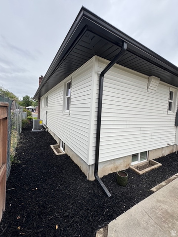189 West Center Street Midvale, UT 84047 - Photo 63 of 64 White horizontal siding with contrasting black soffit, fascia, and gutters