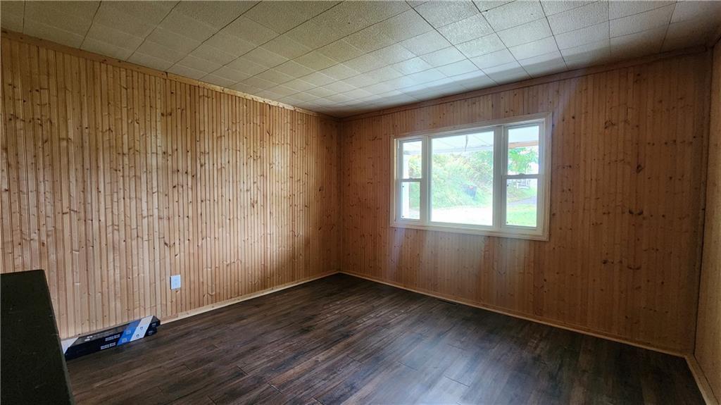 604 North 10th Street Apollo, PA 15613 - Photo 5 of 10 an empty room with wooden floor and windows with curtains