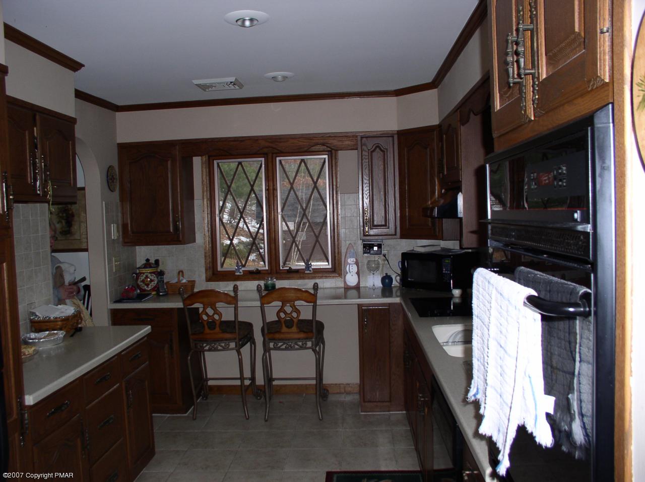 1110 Kroucher Road Stroudsburg, PA 18360 - Photo 4 of 19 a kitchen with sink cabinets and outdoor space