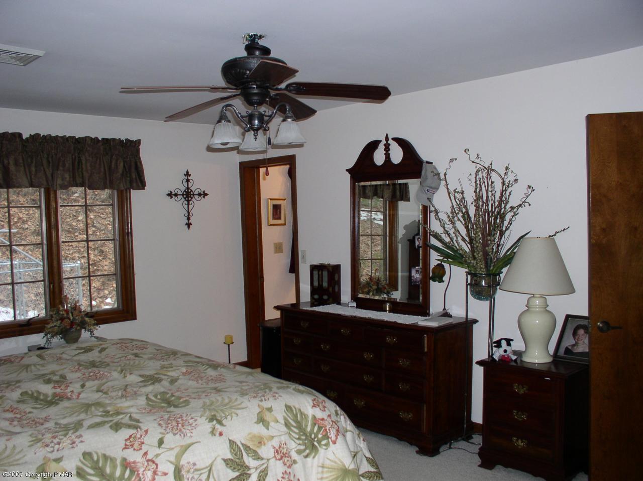 1110 Kroucher Road Stroudsburg, PA 18360 - Photo 7 of 19 a bedroom with a bed a mirror and dresser