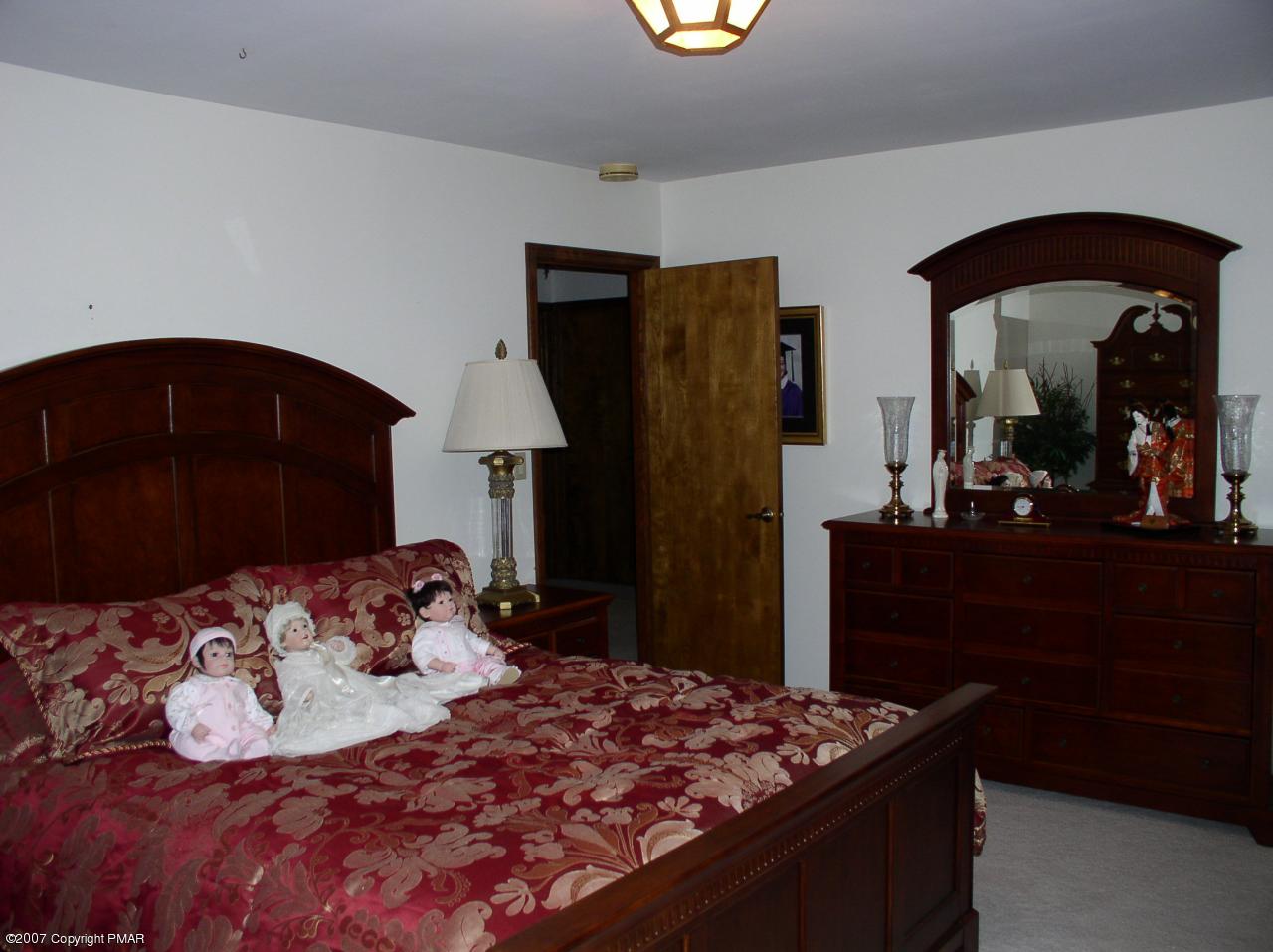 1110 Kroucher Road Stroudsburg, PA 18360 - Photo 8 of 19 a bedroom with a bed and a mirror