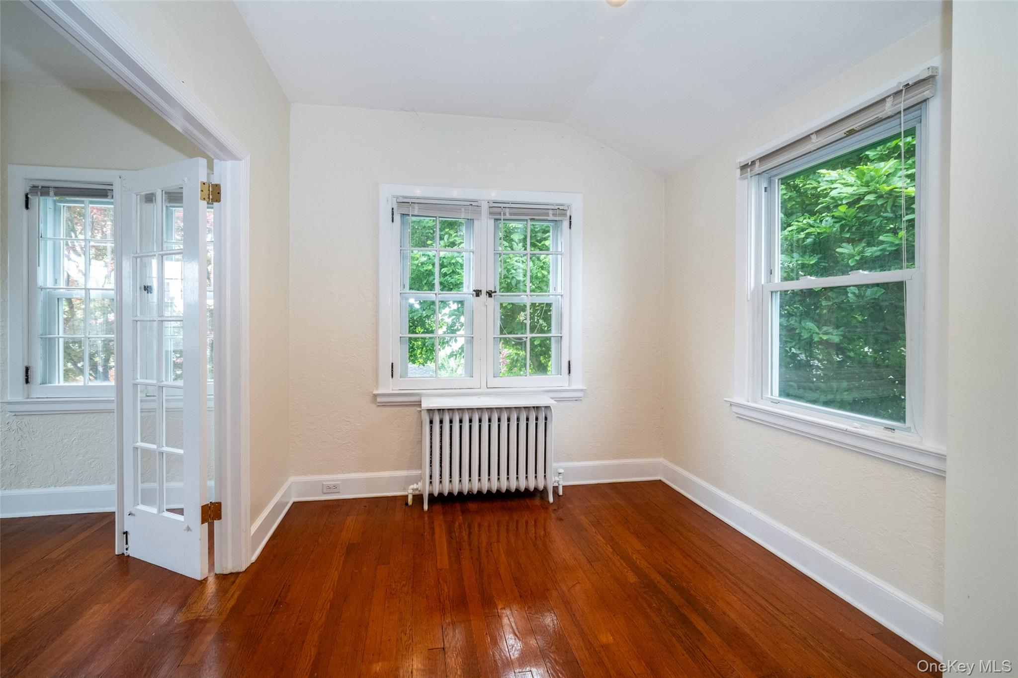 82 Clove Road New Rochelle, NY 10801 - Photo 18 of 39 an empty room with wooden floor and windows