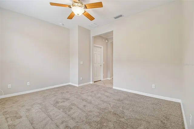 a view of an empty room with a chandelier