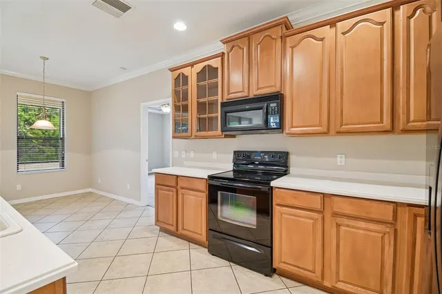 a kitchen with stainless steel appliances granite countertop a sink and a stove