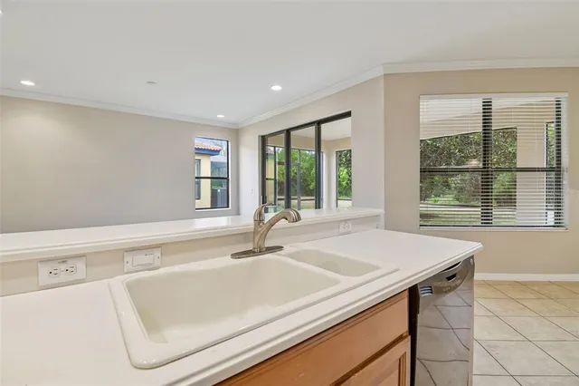 a kitchen with a refrigerator sink and cabinets