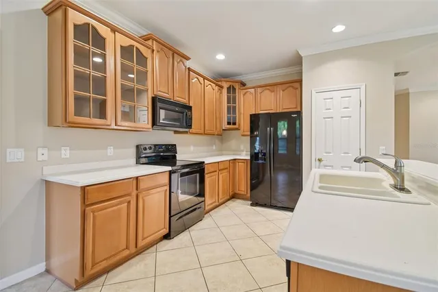a kitchen with stainless steel appliances cabinets a sink and a counter top space