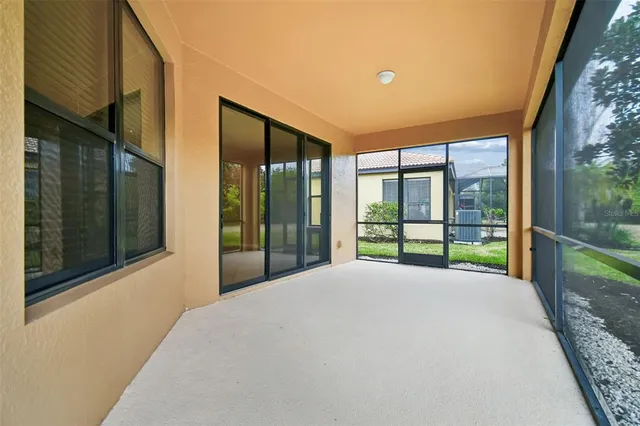 a view of a dining room with furniture a chandelier and wooden floor