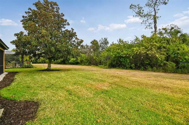 a dining room with lots of furniture a chandelier and wooden floor