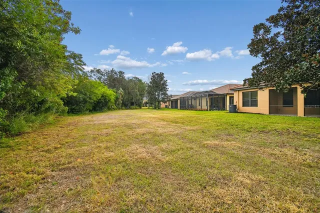 a room with pool table flat screen tv and windows