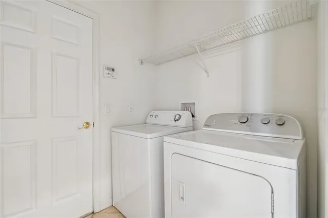 a view of storage and utility room with washer and dryer