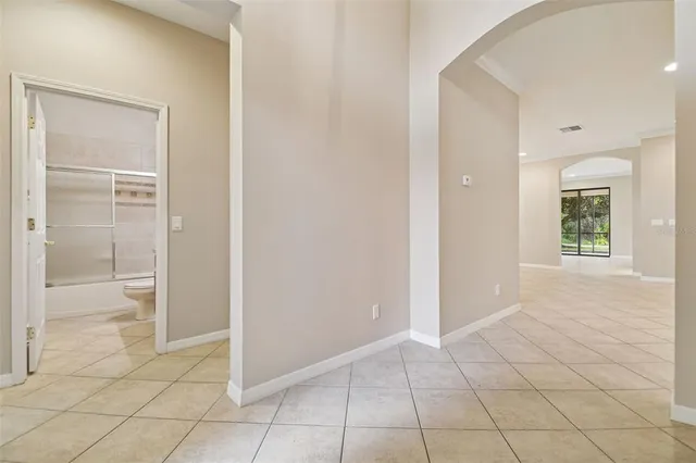 an empty room with a window and a fan