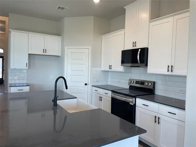 a living room with a fireplace and wooden floor