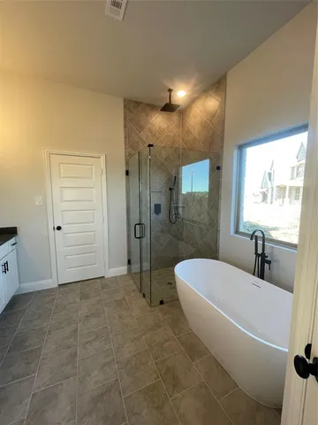 an empty room with windows and ceiling fan view