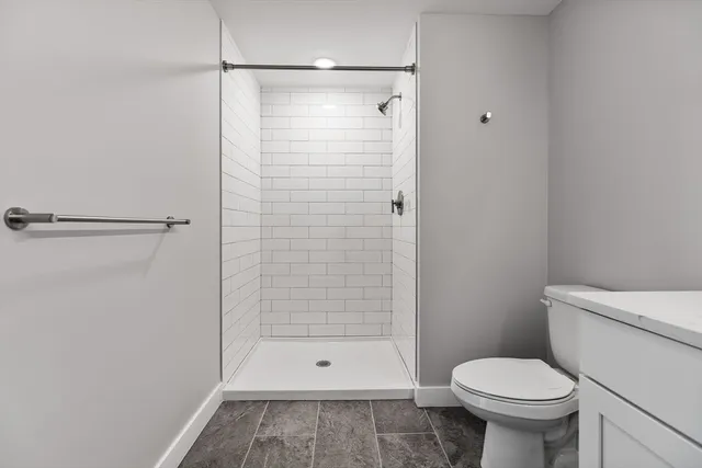 a bathroom with a shower and a toilet