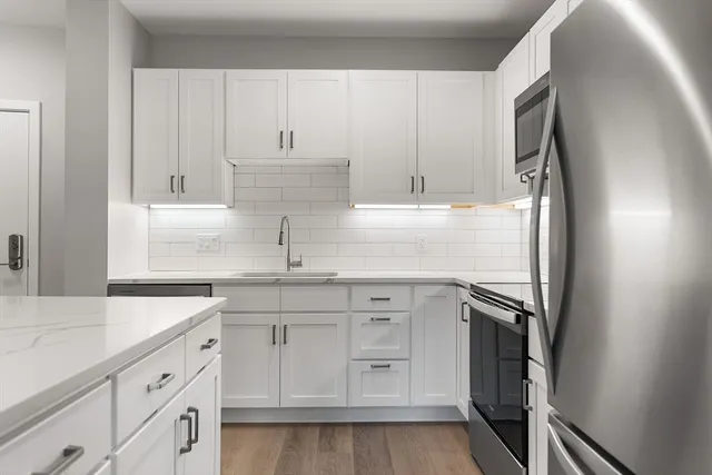 a kitchen with white cabinets and a sink