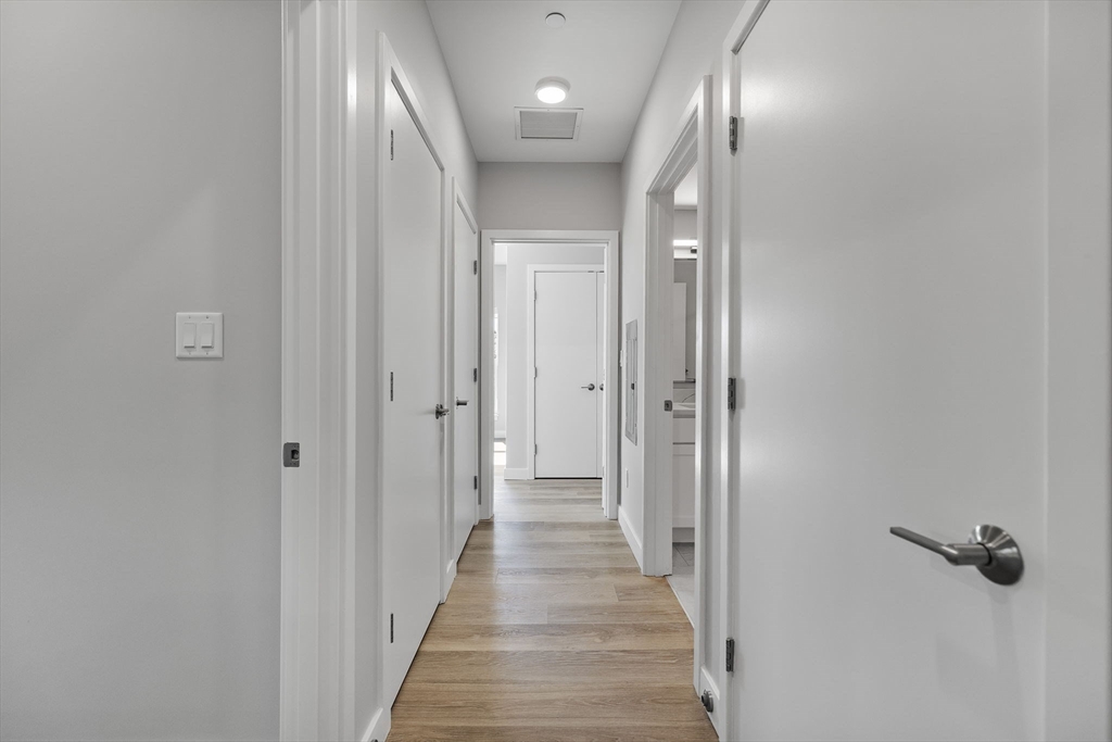 59 Mill Street, Unit 106 Woburn, MA 01801 - Photo 7 of 18 a view of a hallway with wooden floor