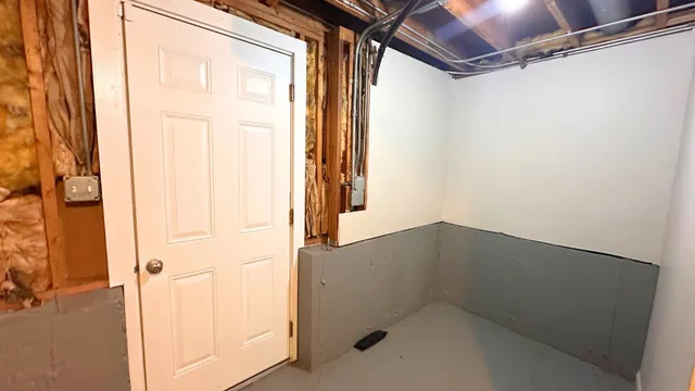 a front view of a house with a yard and trees