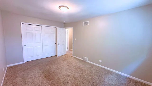 an empty room with closet area