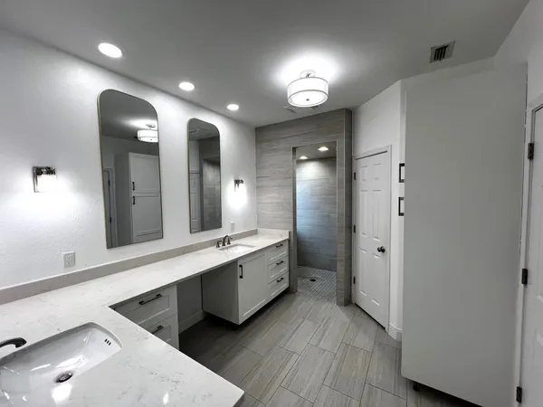 a bathroom with a double vanity sink and a mirror
