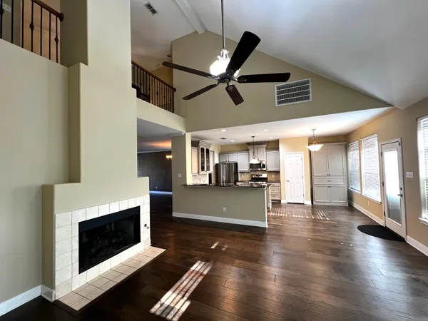 a view of a livingroom with furniture fireplace and wooden floor