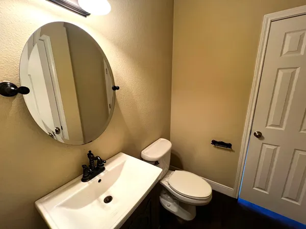 a bathroom with a toilet sink and mirror