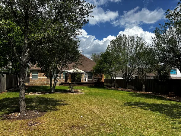 a view of a yard with a house in the background