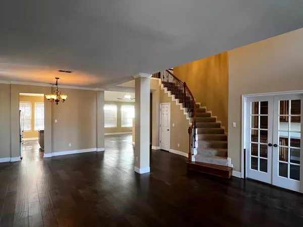 a view of an entryway with wooden floor and door
