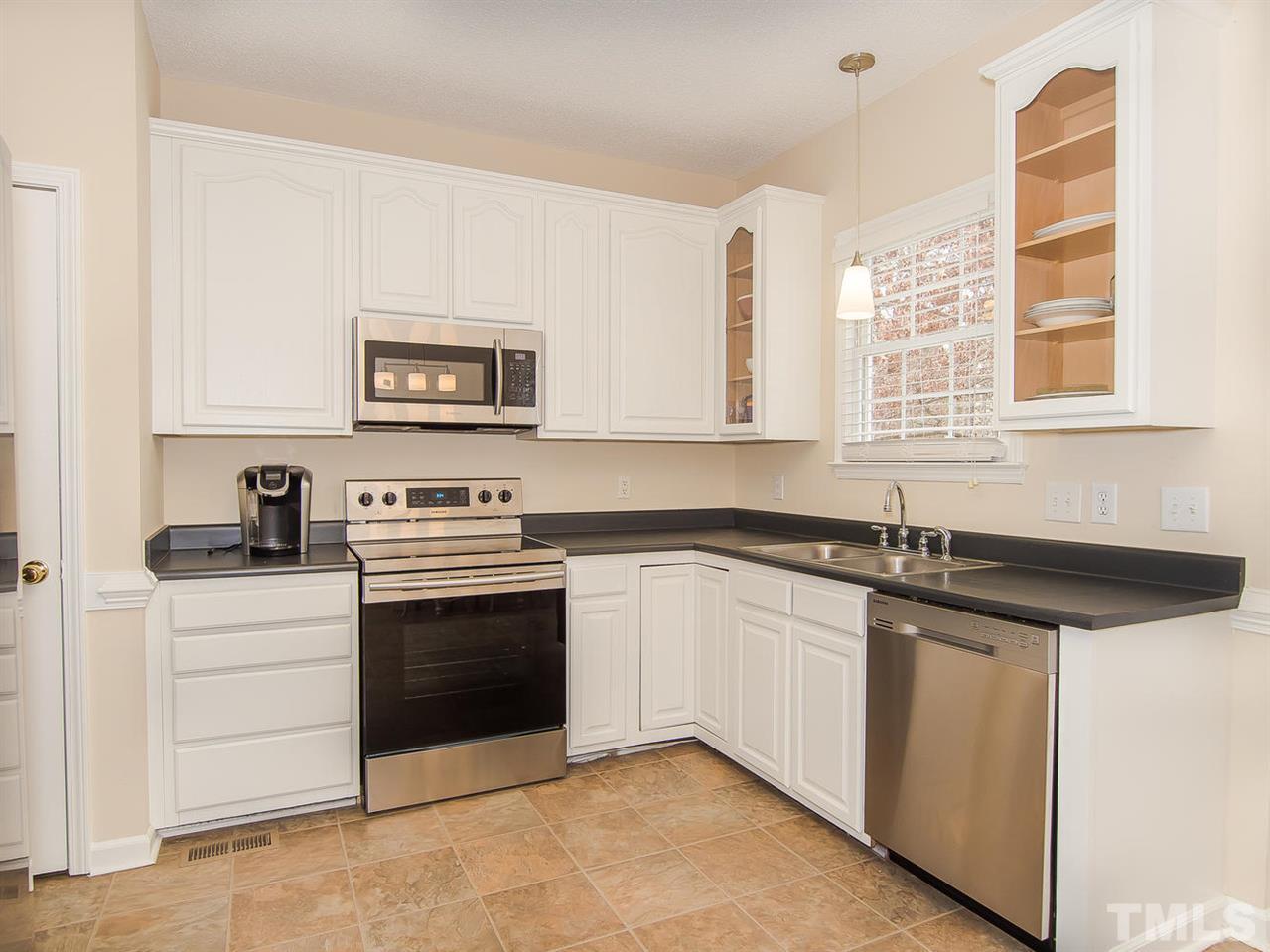 5424 Stewartby Drive Raleigh, NC 27613 - Photo 13 of 25 a kitchen with stainless steel appliances granite countertop a stove and a sink