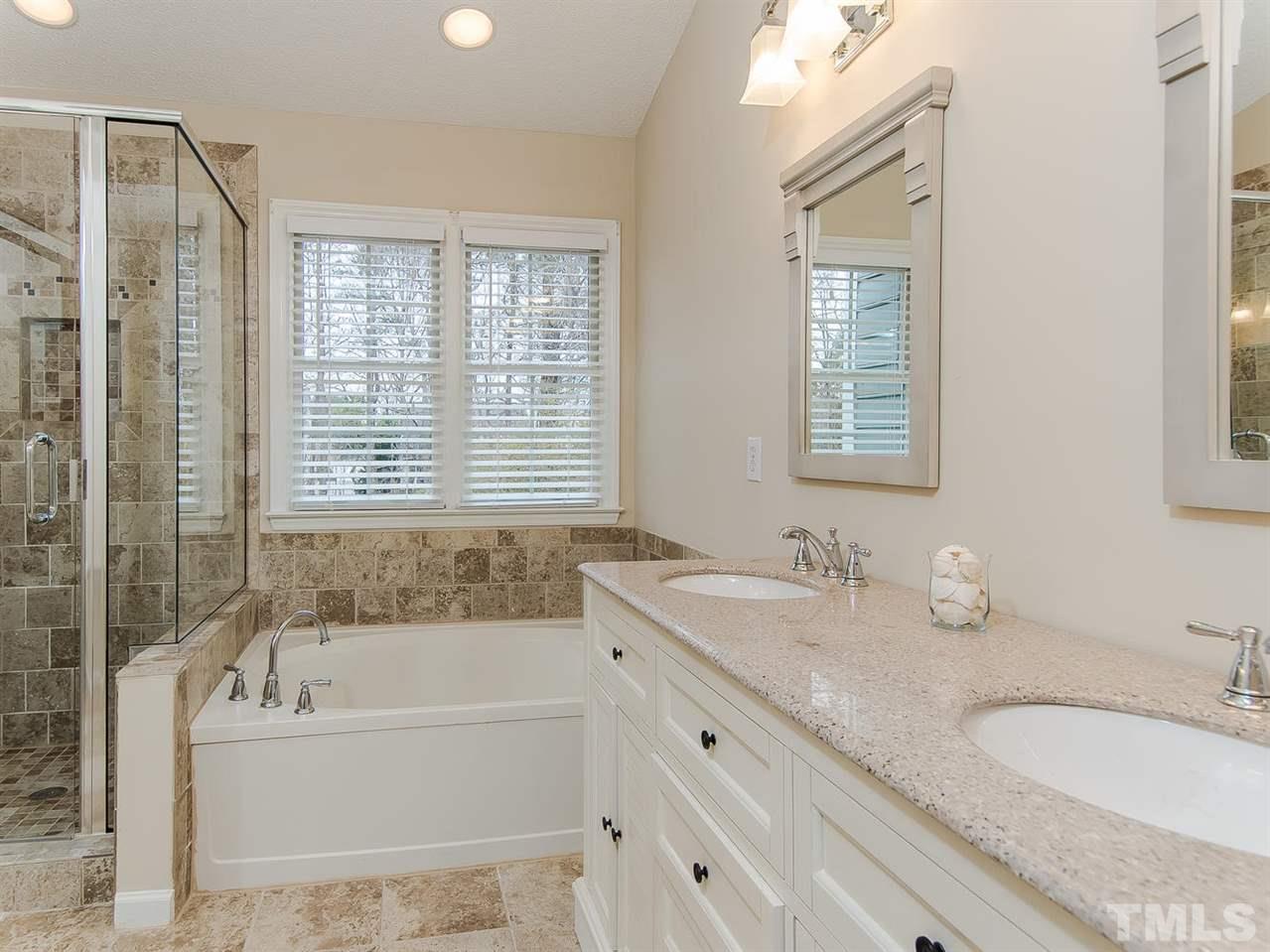 5424 Stewartby Drive Raleigh, NC 27613 - Photo 15 of 25 a bathroom with a granite countertop tub sink and mirror