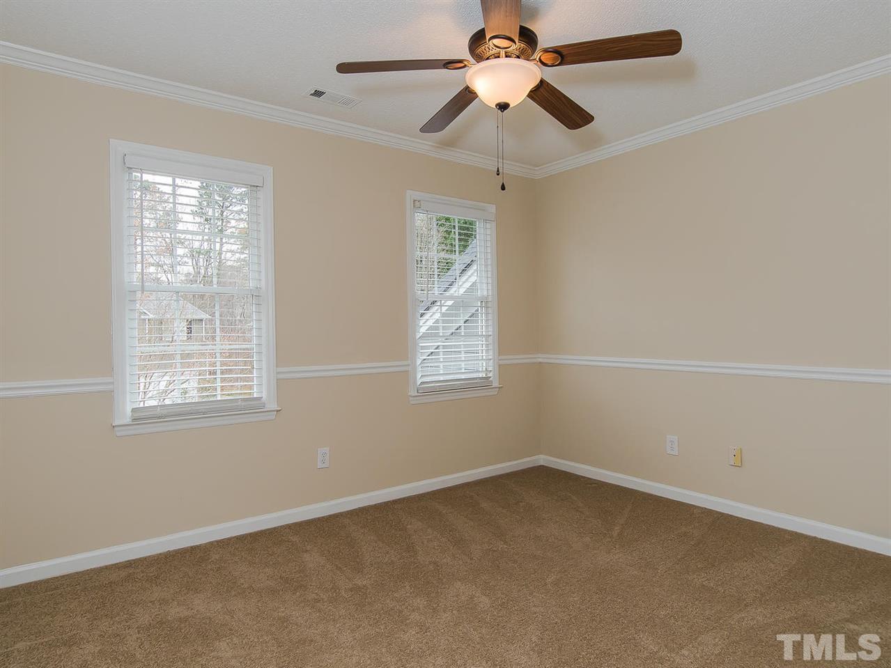 5424 Stewartby Drive Raleigh, NC 27613 - Photo 20 of 25 an empty room with a window and a fan