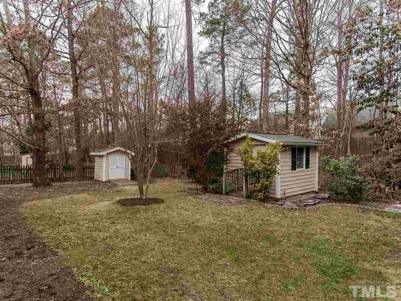 5424 Stewartby Drive Raleigh, NC 27613 - Photo 23 of 25 a view of a house with large tree and wooden fence