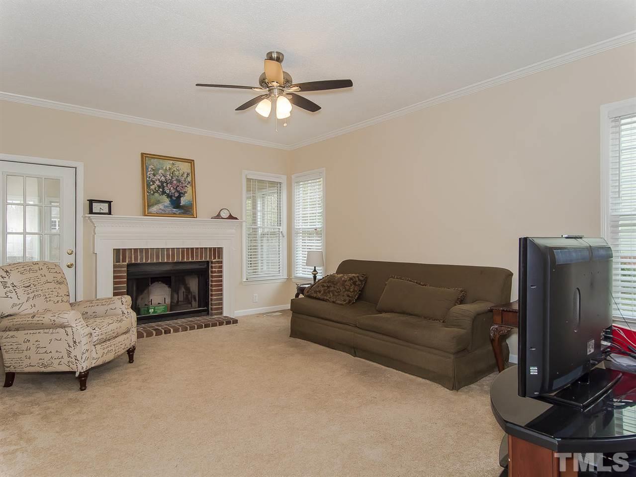 5424 Stewartby Drive Raleigh, NC 27613 - Photo 4 of 25 a living room with furniture and a fireplace