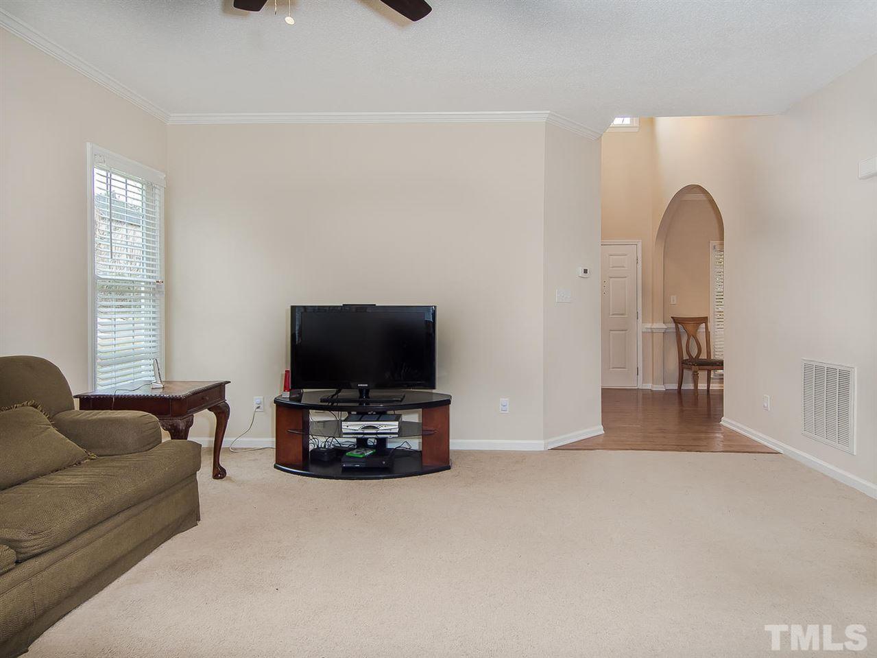 5424 Stewartby Drive Raleigh, NC 27613 - Photo 5 of 25 a living room with furniture and a flat screen tv