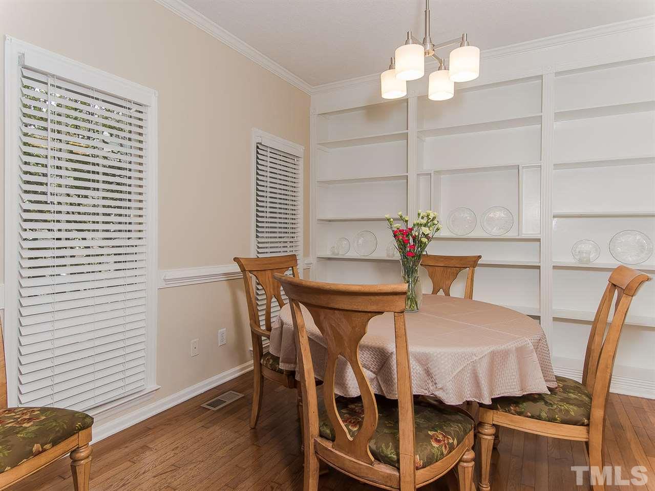 5424 Stewartby Drive Raleigh, NC 27613 - Photo 7 of 25 a view of a dining room with furniture and wooden floor
