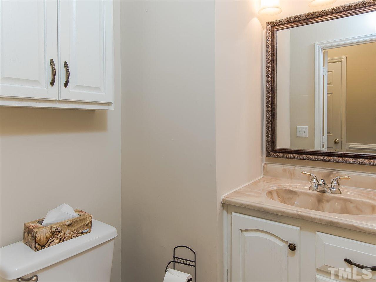 5424 Stewartby Drive Raleigh, NC 27613 - Photo 9 of 25 a bathroom with a sink and a mirror