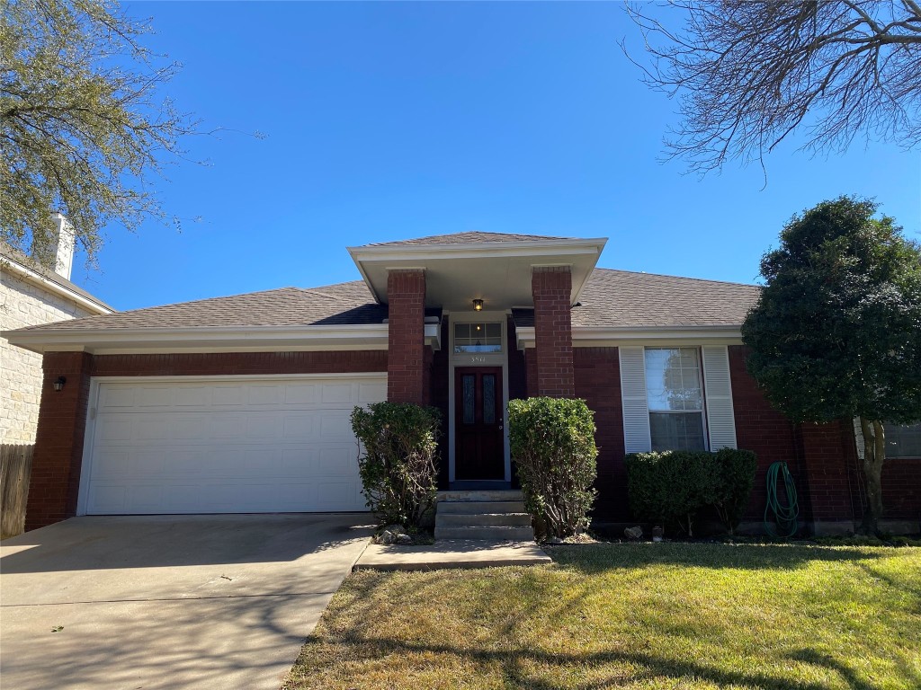 a view of a house with potted plants and a large tree