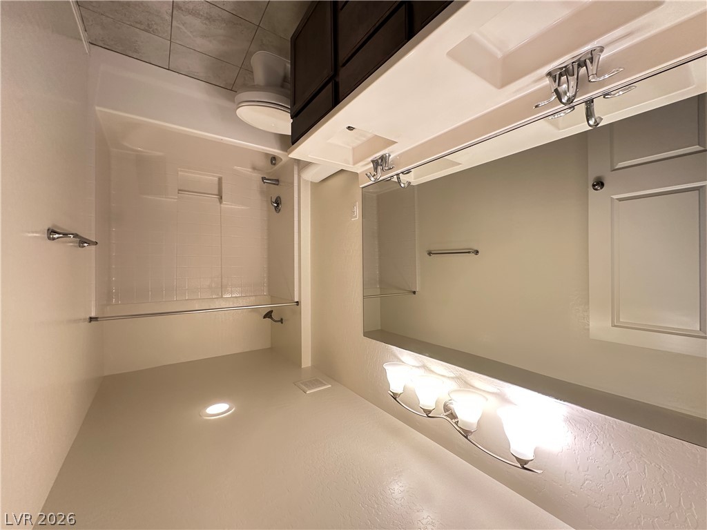 6784 Pivot Point Street Las Vegas, NV 89148 - Photo 19 of 27 A well-lit bathroom with a shower and vanity provides functional comfort.