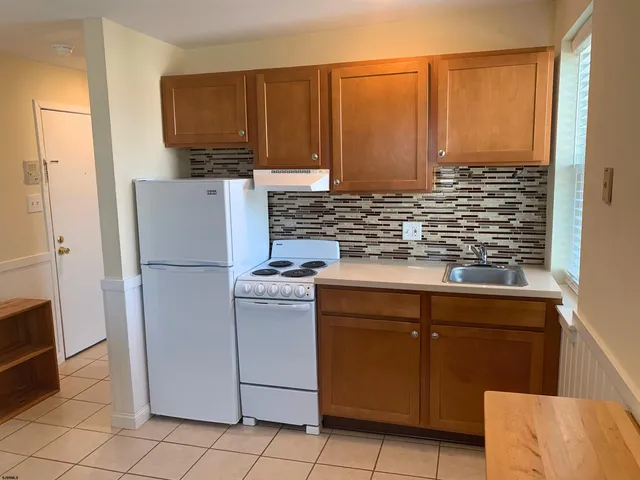 a kitchen with cabinets and steel stainless steel appliances