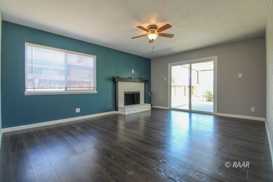 420 Lenore Street Ridgecrest, CA 93555 - Photo 5 of 29 an empty room with wooden floor chandelier and glass door
