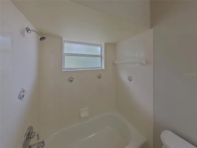 a bathroom with a bathtub and shower