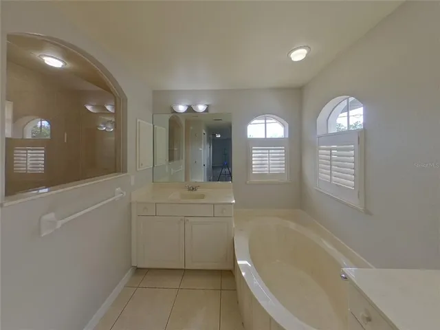 a spacious bathroom with a bathtub and a sink