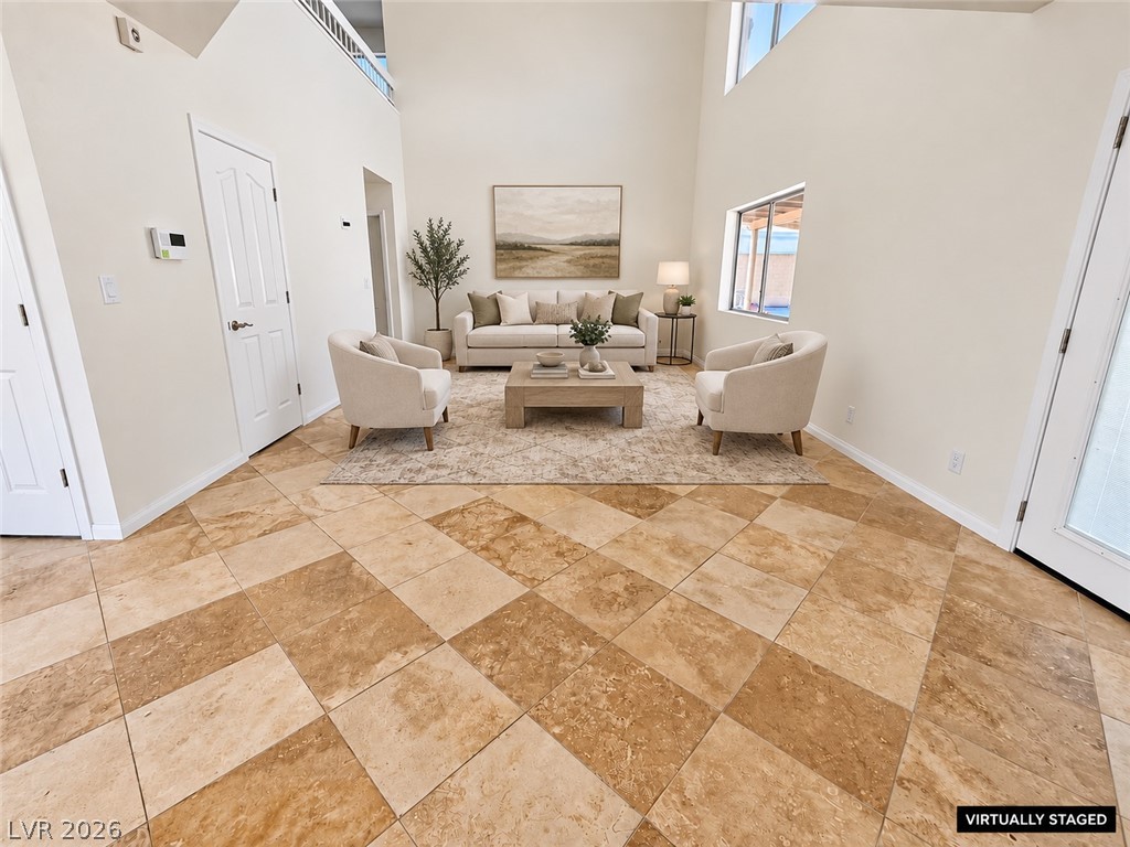 43 Bayridge Road Henderson, NV 89074 - Photo 19 of 47 Geometric tile flooring runs throughout a spacious room beneath soaring, double-height ceilings.